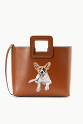 Tan leather tote bag with top handle and puppy graphic on front