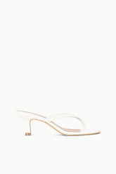 White open-toe kitten-heel sandals from the side, slim heel and thin crisscross straps