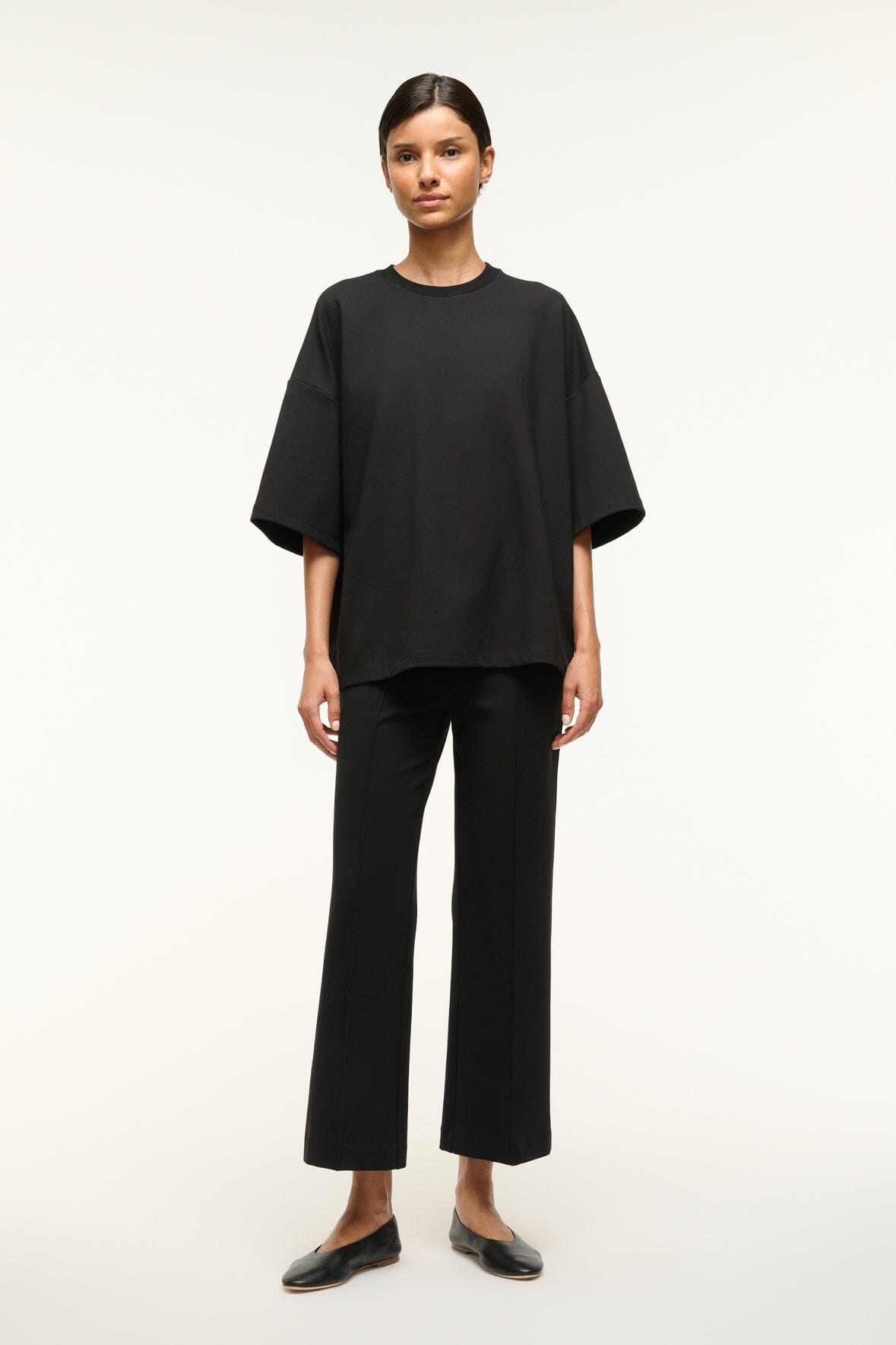 Black capsule top with short sleeves and crew neckline