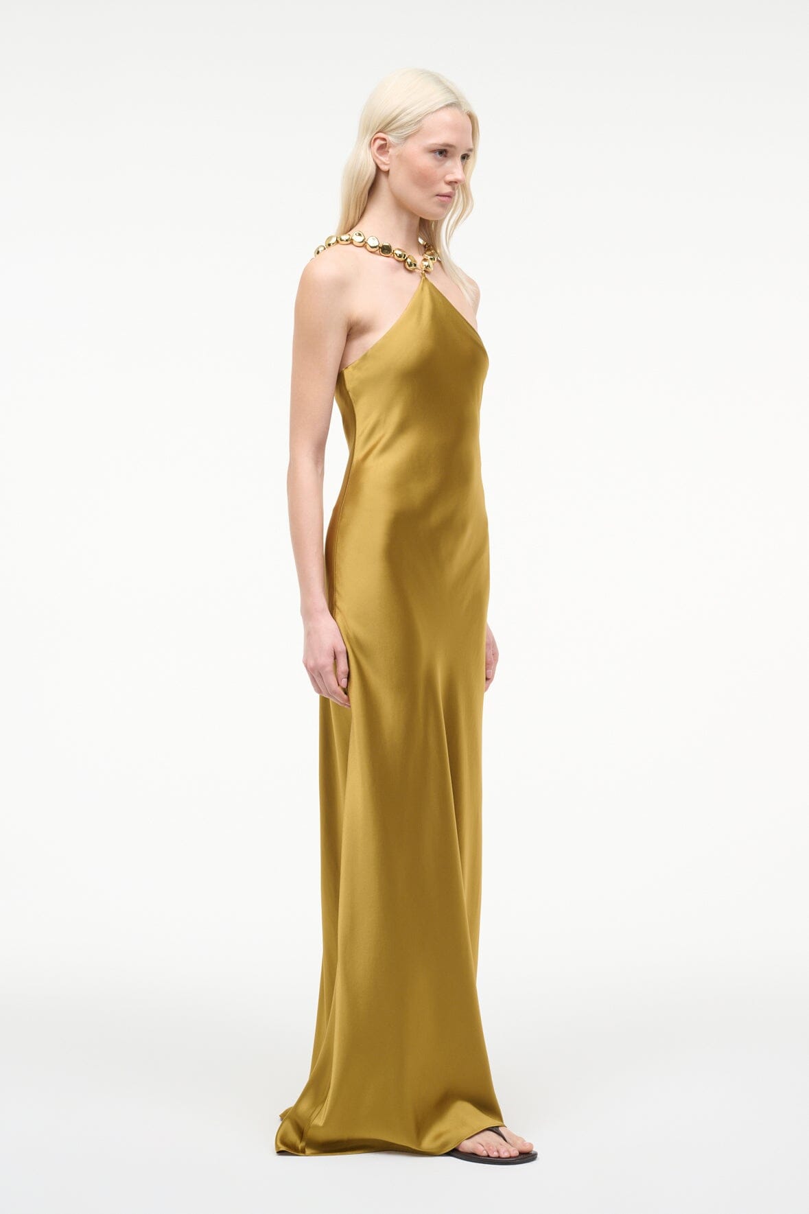 Gold satin halter maxi slip dress with open back and sleek drape