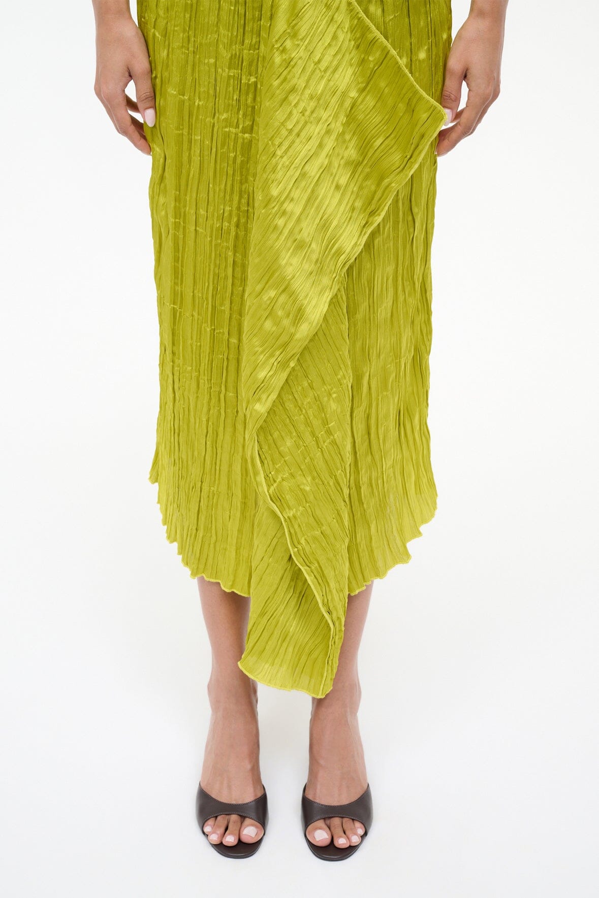 Green crinkled midi skirt with diagonal seams and asymmetrical hem
