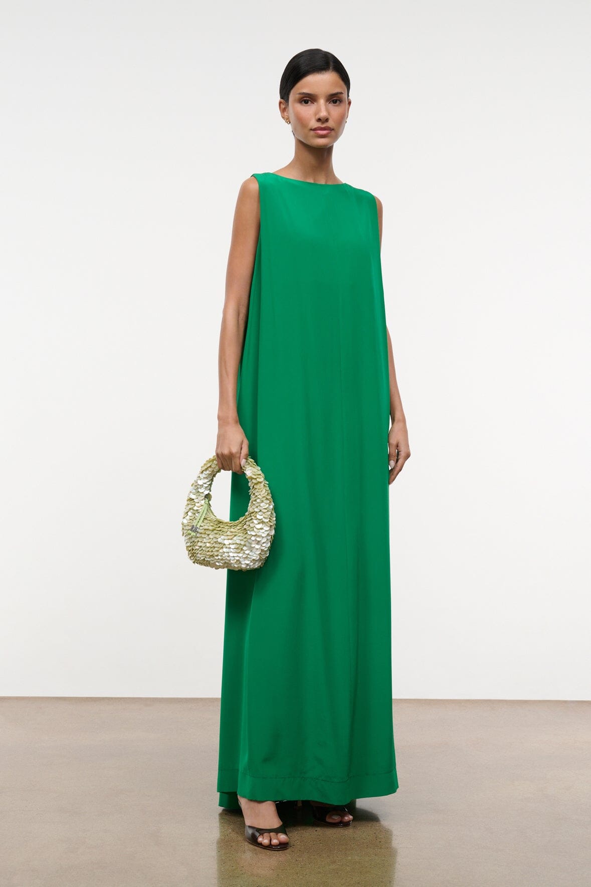 Green sleeveless maxi silk dress with crew neckline and draped fall
