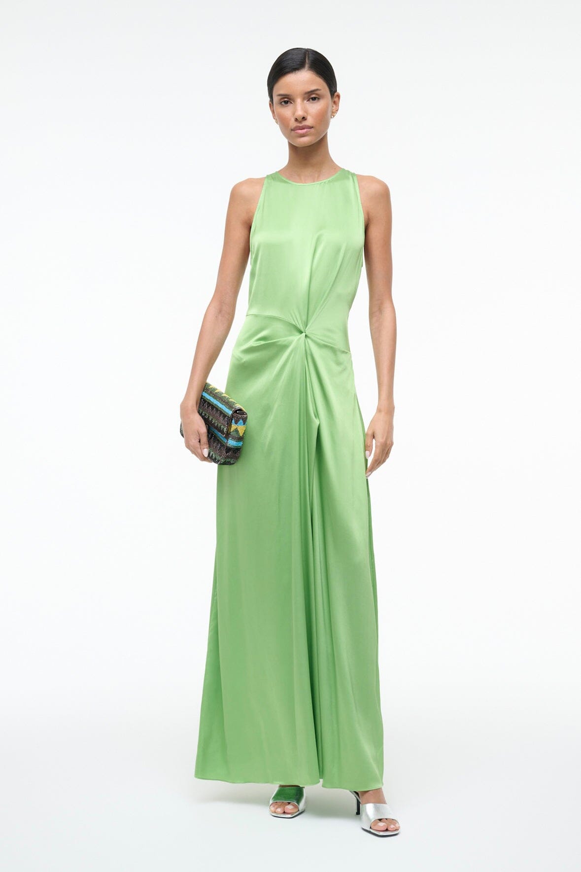 Green silk sleeveless maxi dress with gathered waist knot and flowing floor-length skirt