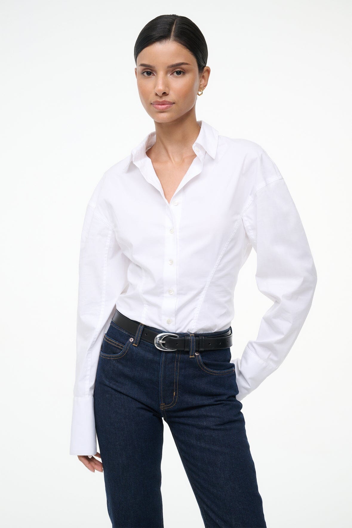 White button-up top with long sleeves and front button placket