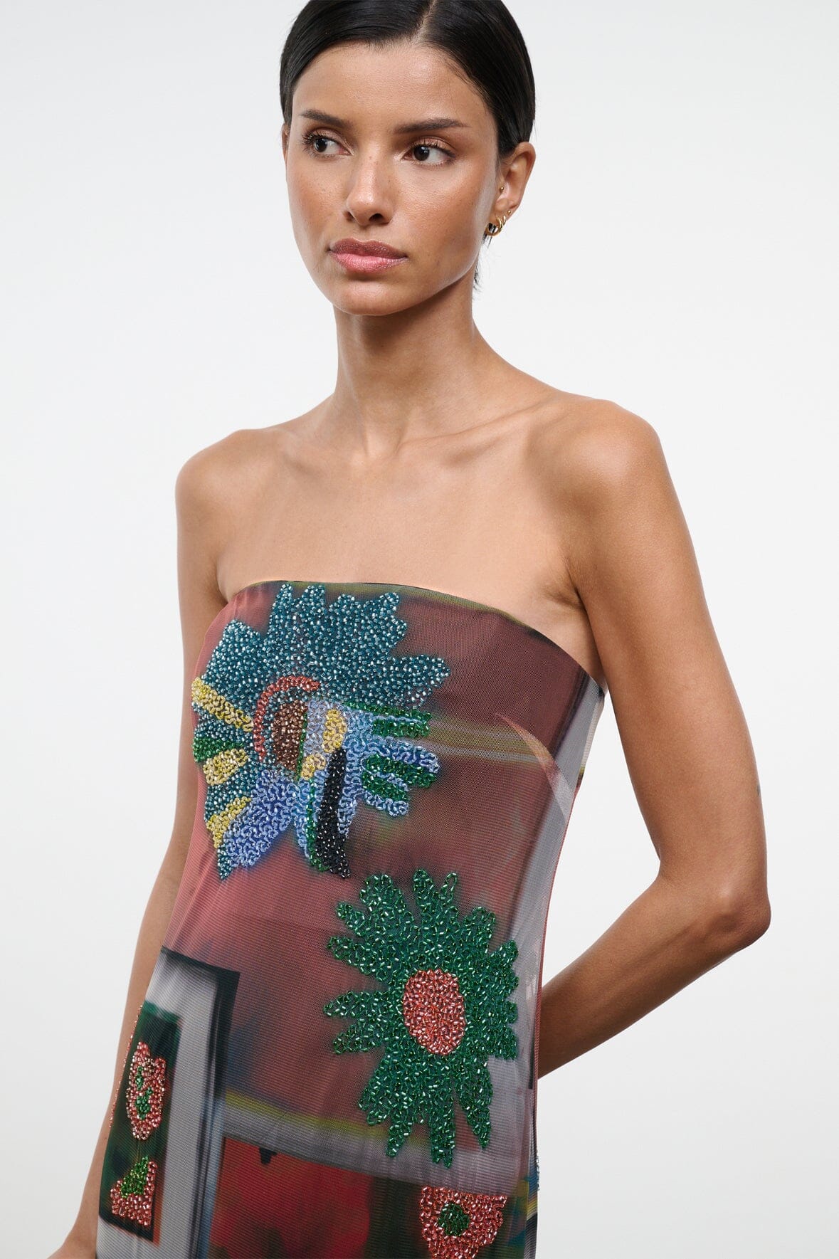 Strapless dress close-up: sheer multicolor mesh with green-blue-red beaded flowers