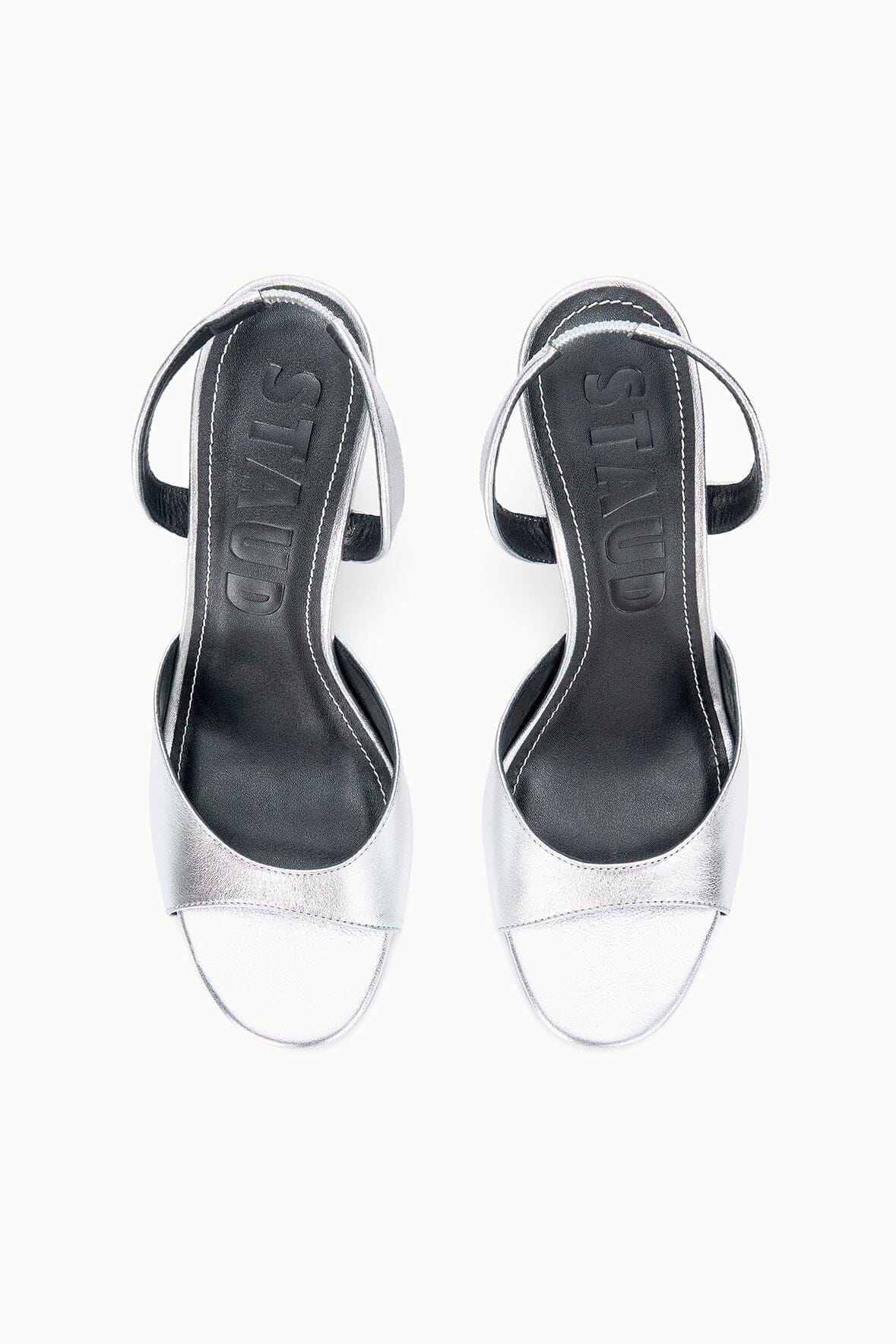 Pair of silver heeled sandals with open toe and slingback straps