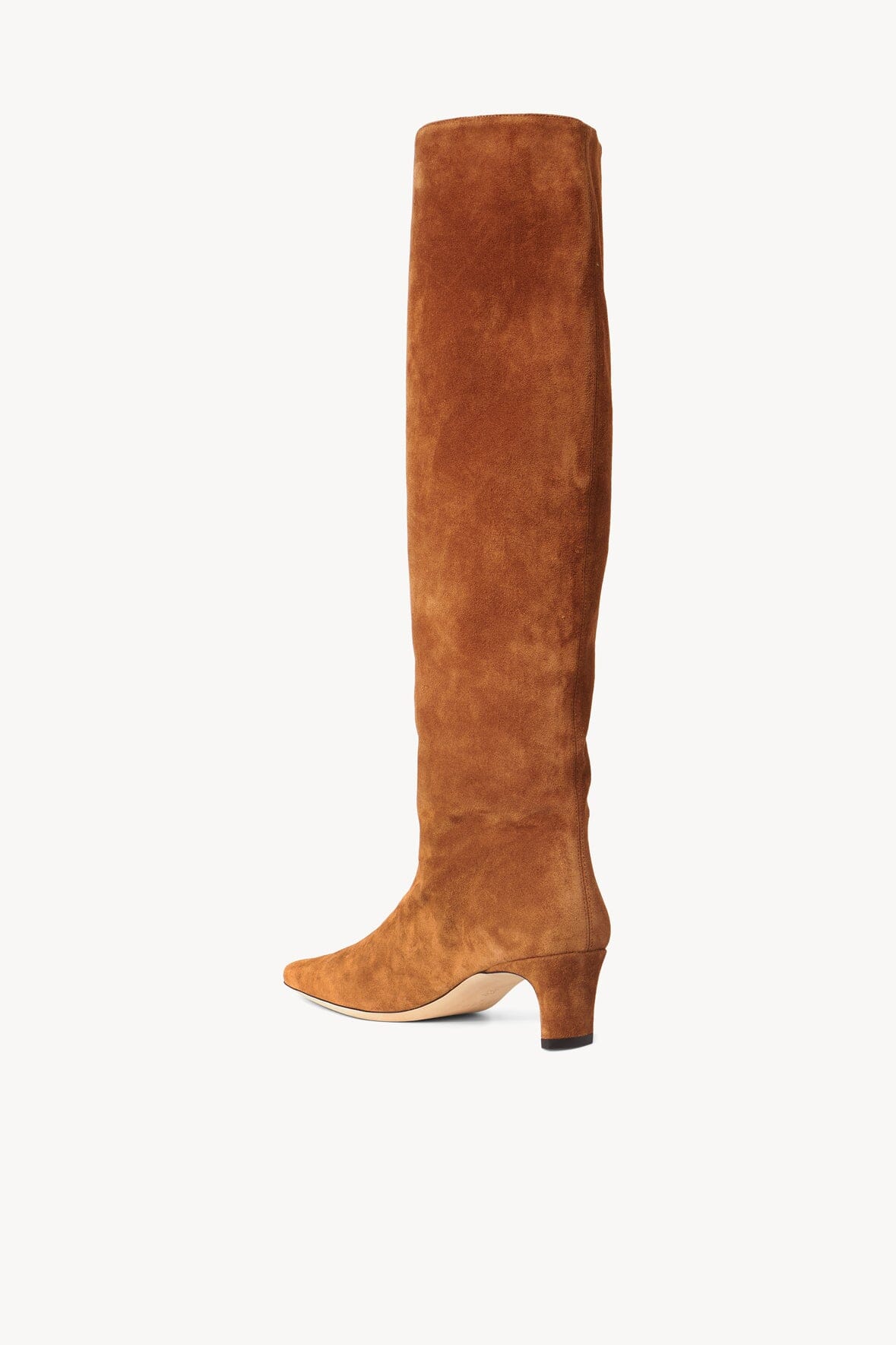Tan suede tall boot with low stacked heel and pointed sole