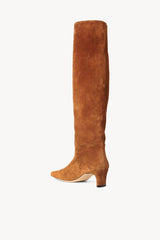 Tan suede tall boot with low stacked heel and pointed sole