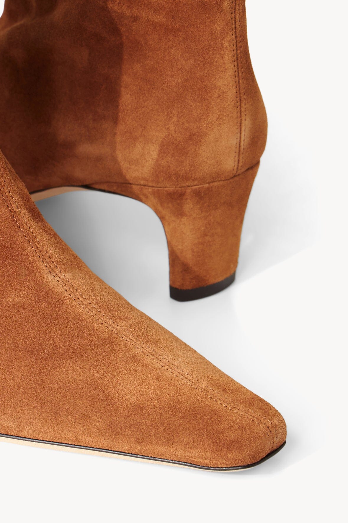 Tan suede boot with stitched ankle seam and low heel