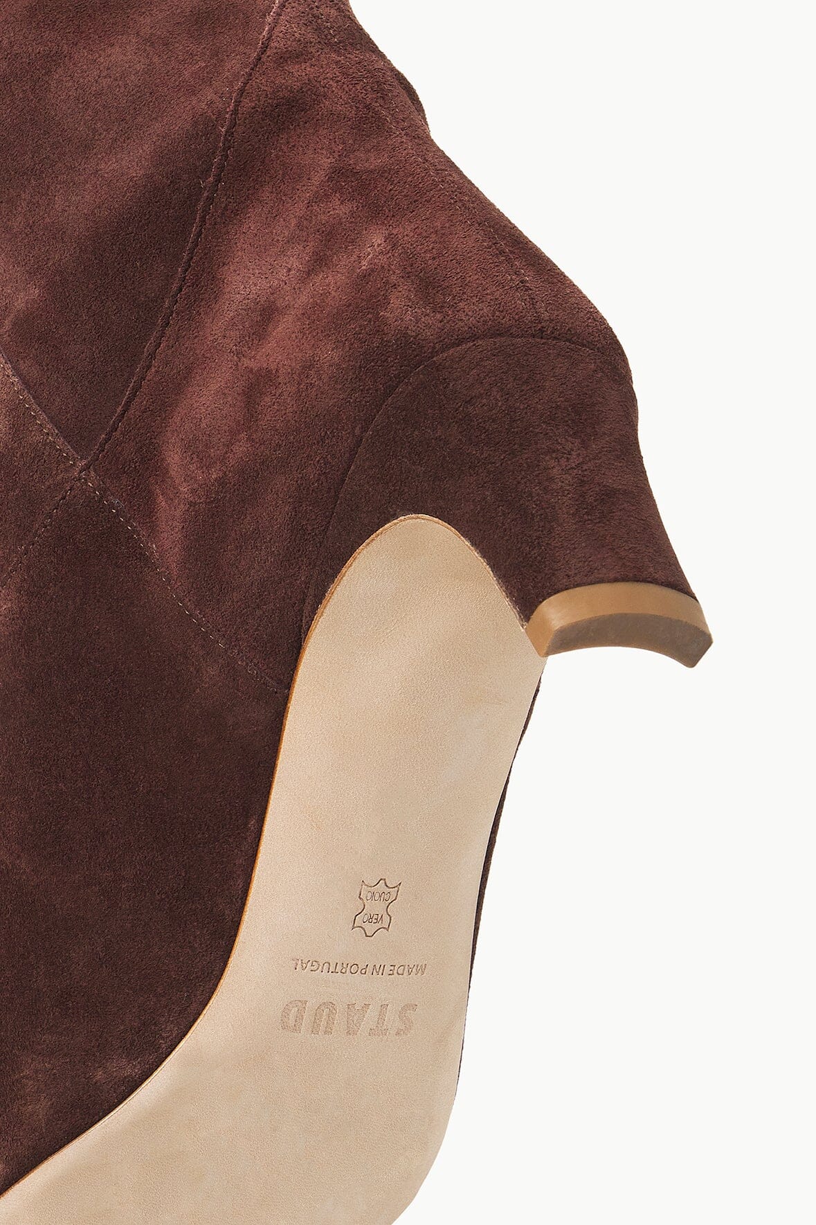 Mahogany suede boot shaft detail with cream sole and low heel