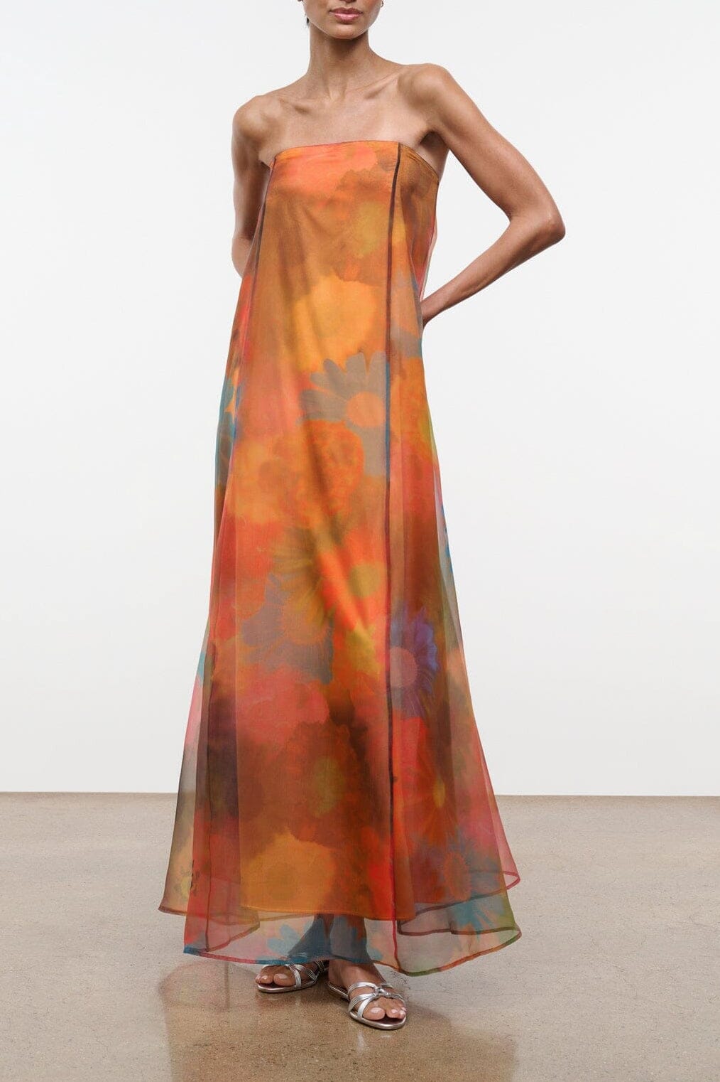 Strapless maxi dress with orange floral print and flowing sheer skirt