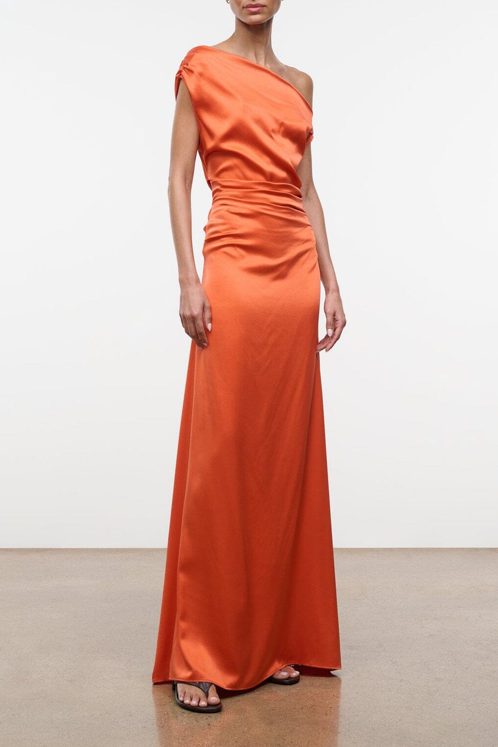 One-shoulder orange silk maxi dress with draped bodice and side ruching